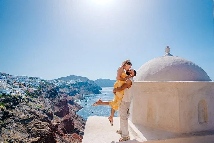 Couple on a whitewashed Oia stairway on a private Santorini photoshoot walk, Santorini Greece
