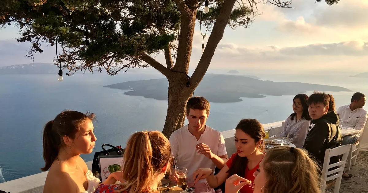 Caldera path at dusk on a sunset walking tour with local food, Santorini Greece