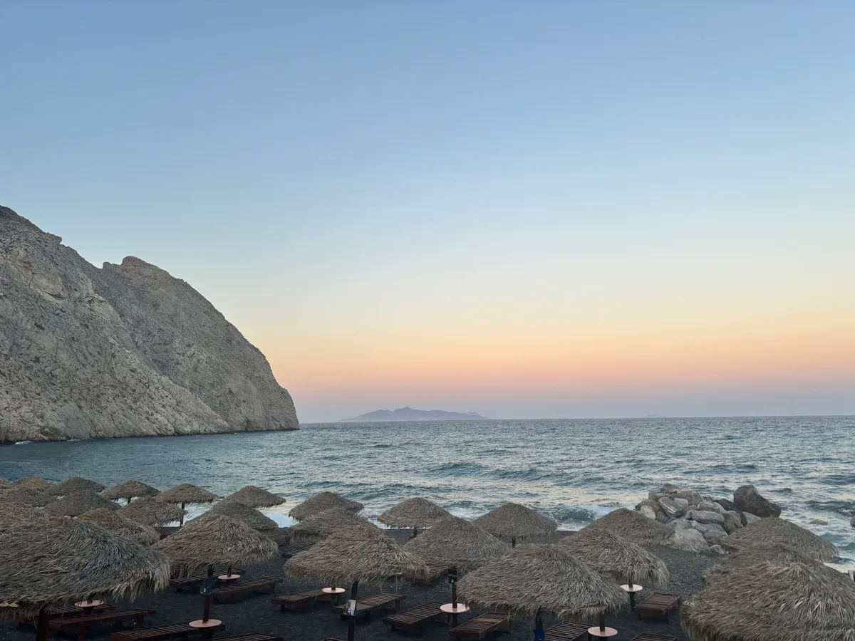 Perissa beach and Mesa Vouno at sunset, where to stay in Santorini